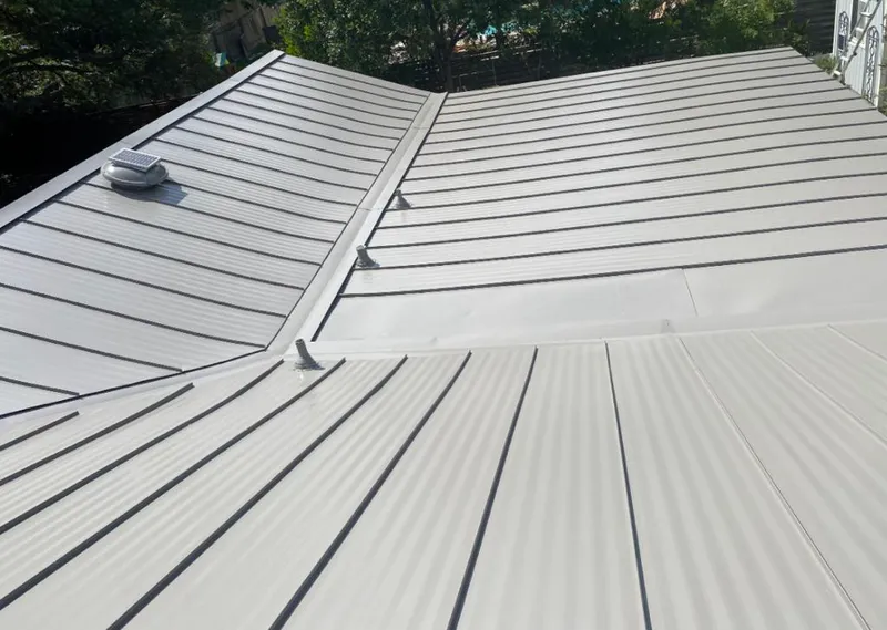 Solar attic fan installed on a metal roof for Roof Ventilation in Falls